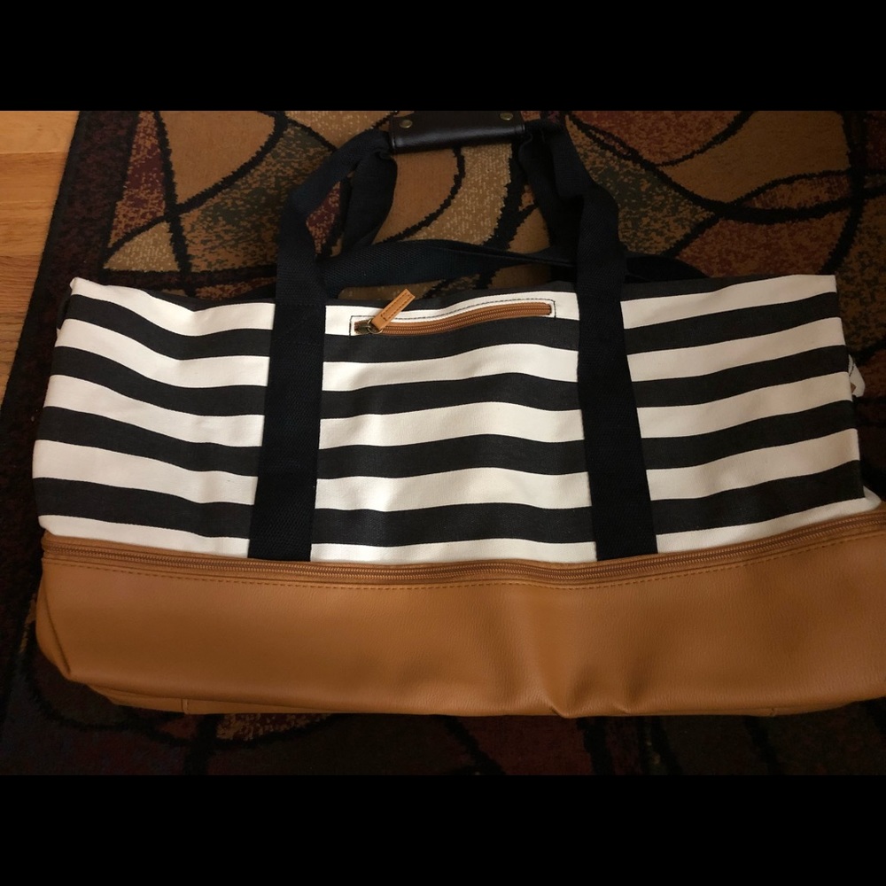 Black and white striped duffle bag with shoe compartment at bottom